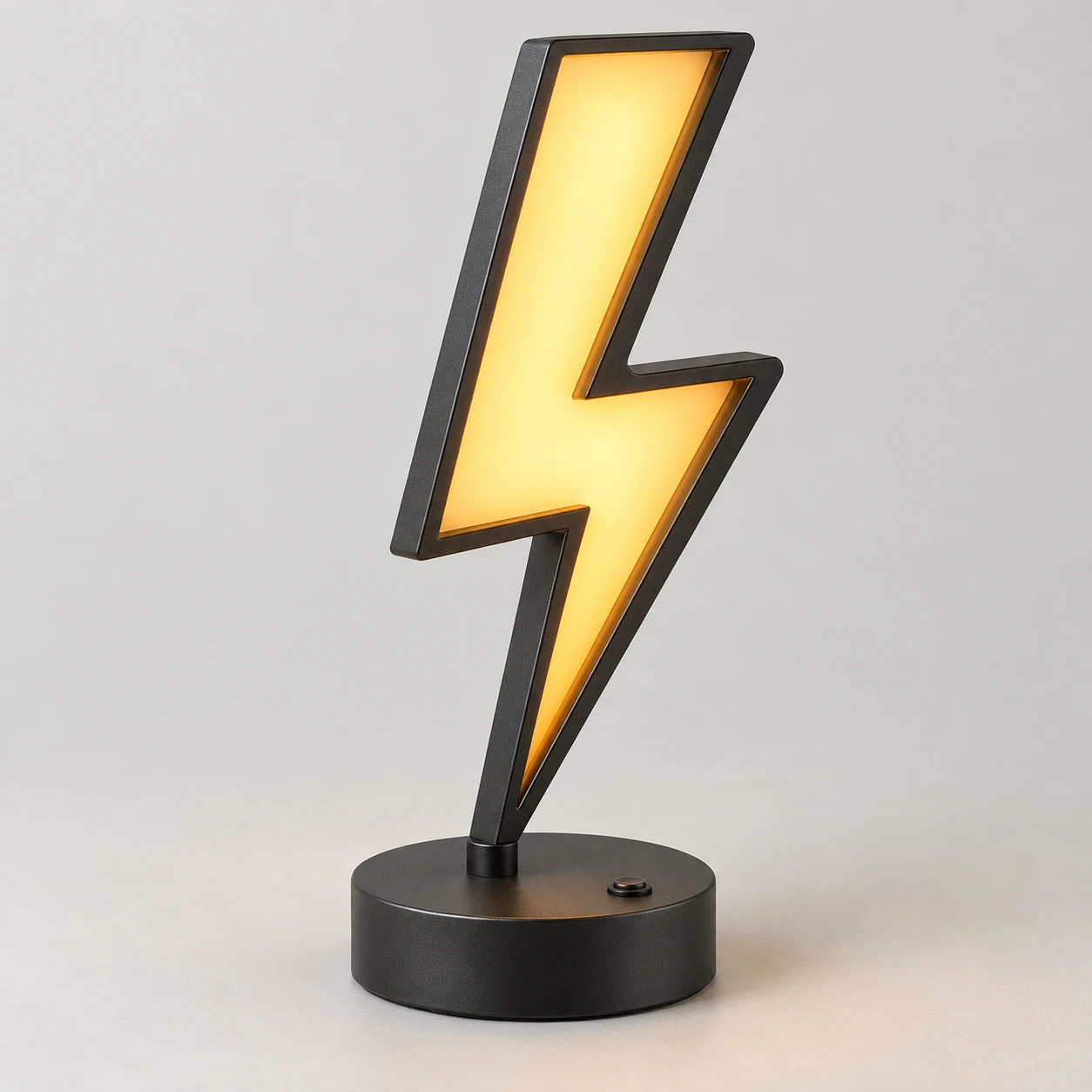 Amber lightning-bolt desk lamp with a charcoal frame and round base.
