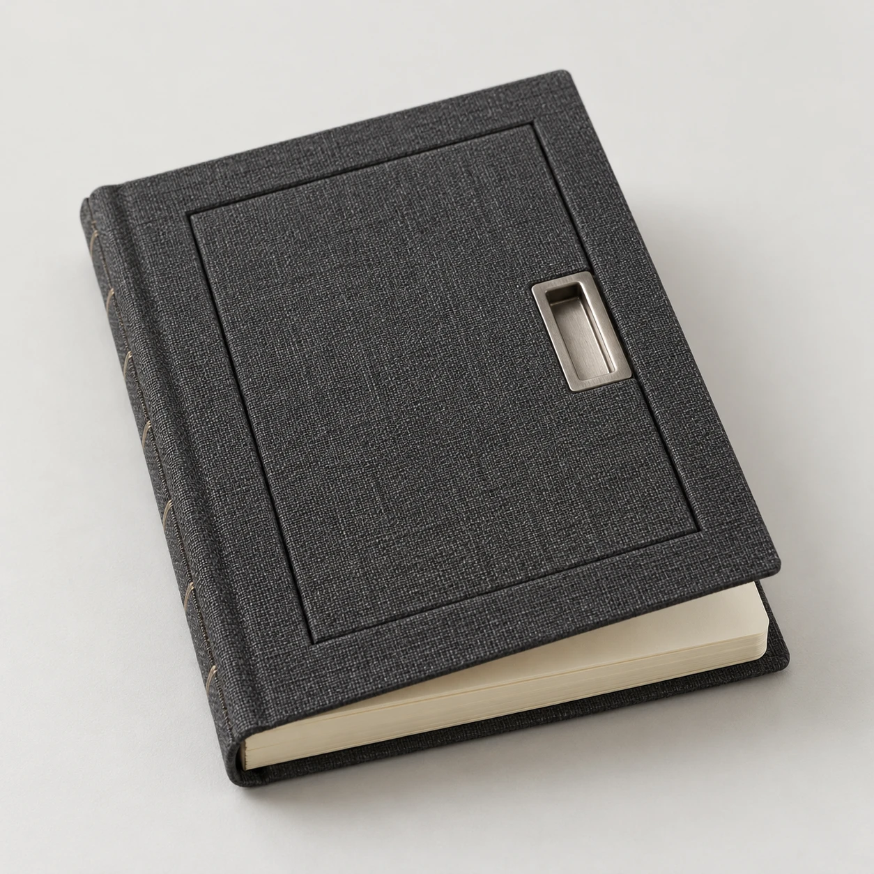 Charcoal cloth notebook with a hatch-shaped cover and recessed metal pull.