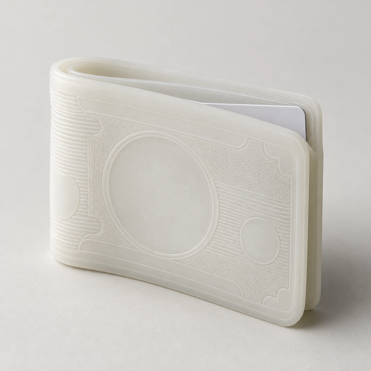 Studio photograph of a pale translucent banknote-shaped silicone card wallet.